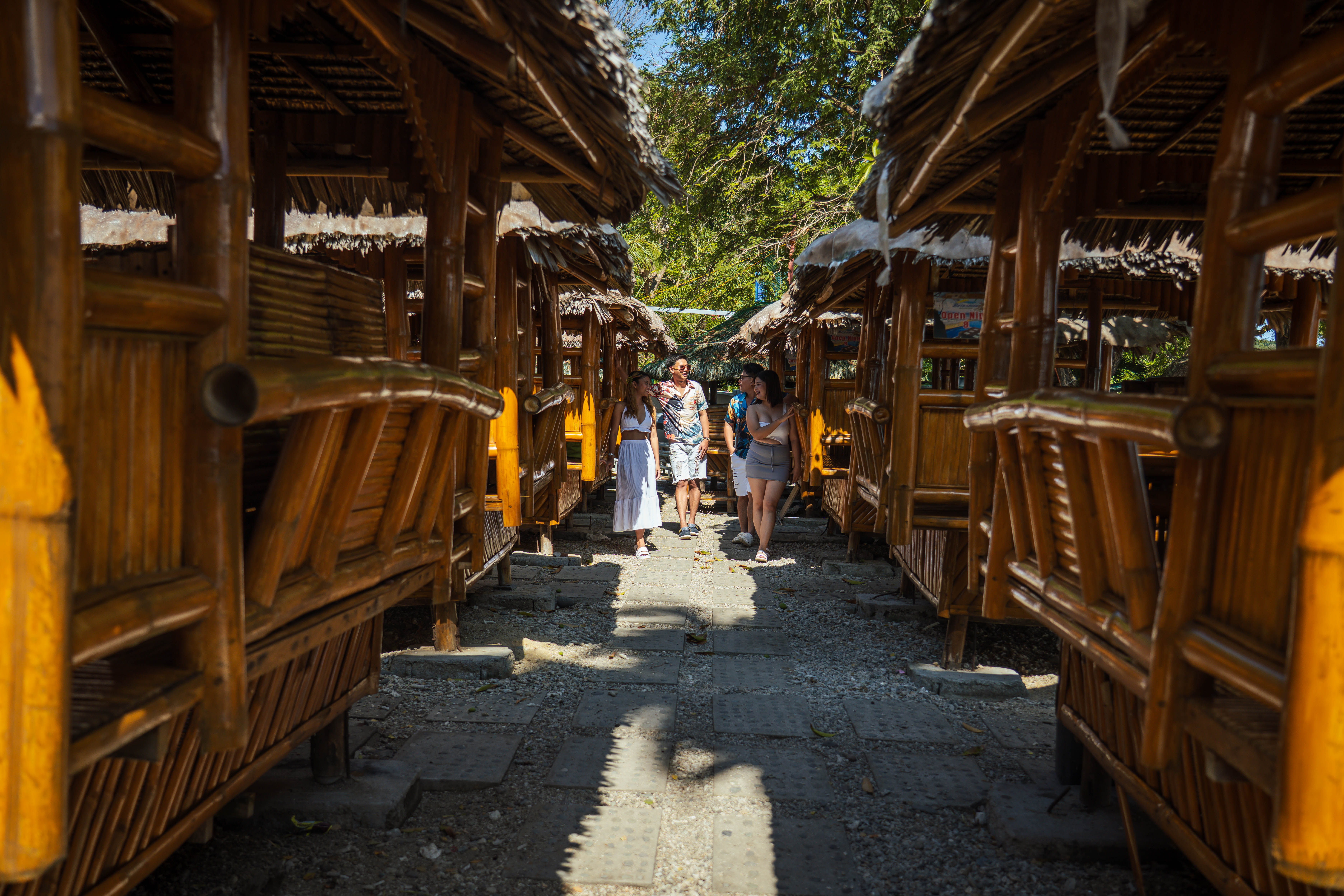 Traditional bamboo cabana cottages along the beachfront pathway at Brizamar Beach Resort Ilihan Batangas