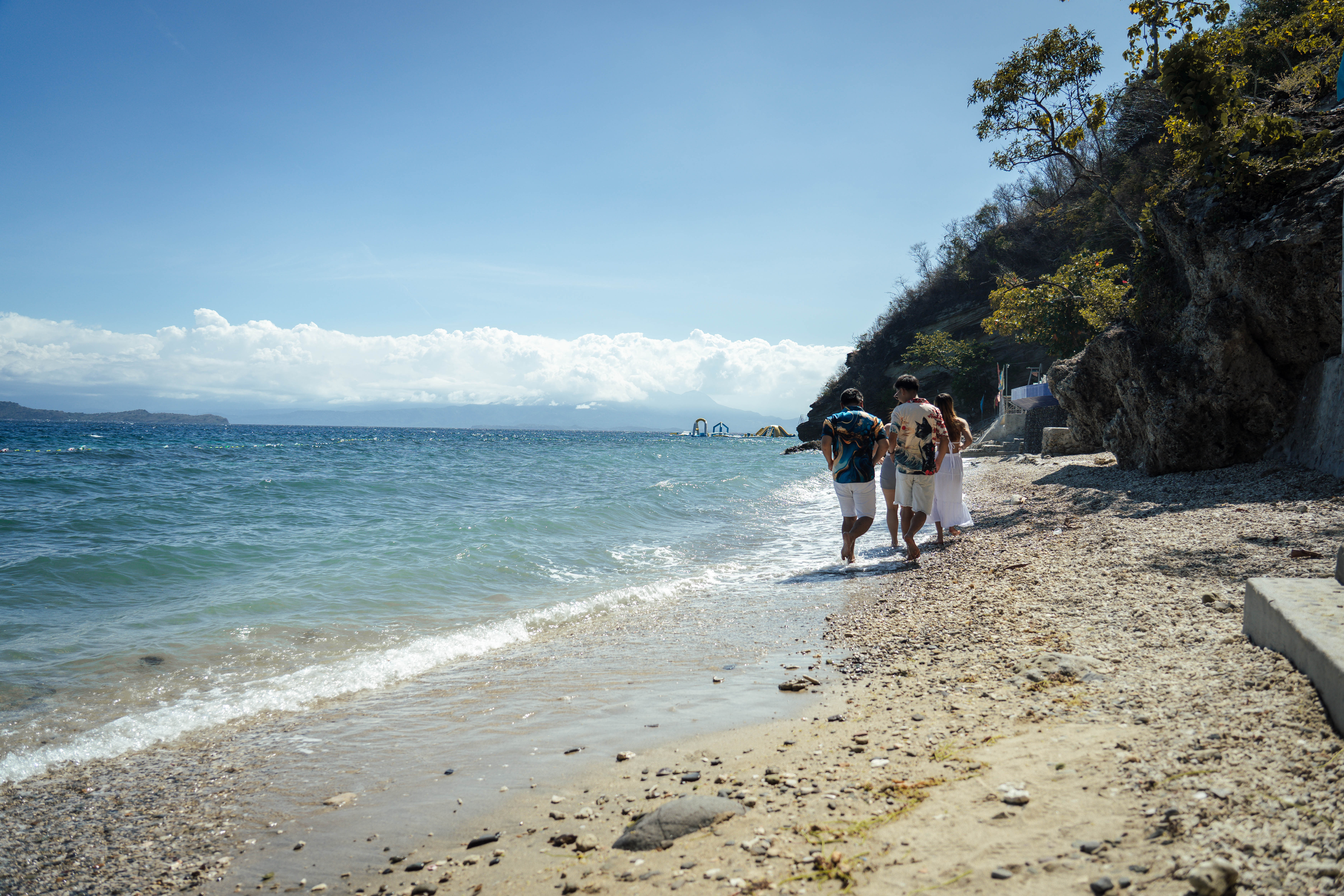Guests walking along the beach at Brizamar Beach Resort