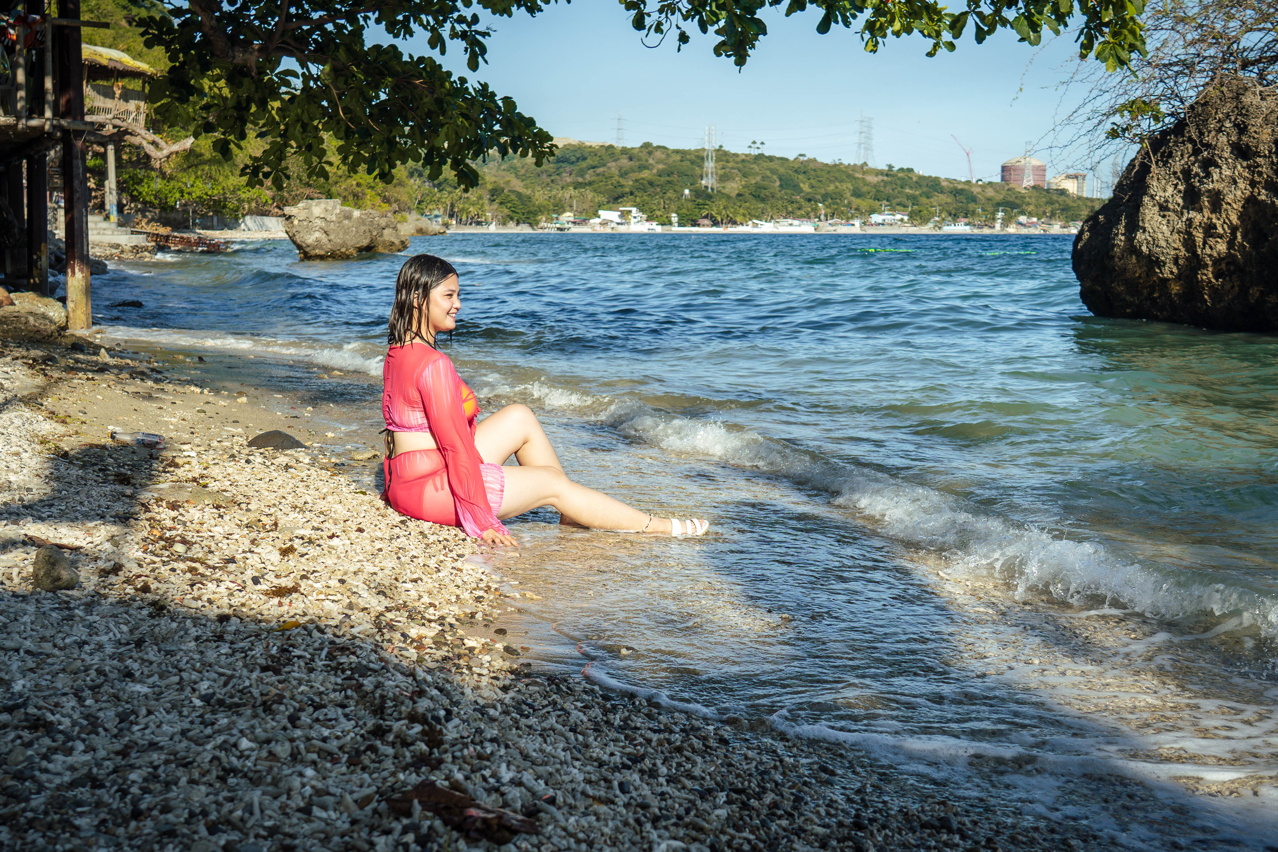 Guest relaxing by the shore at Brizamar Beach Resort