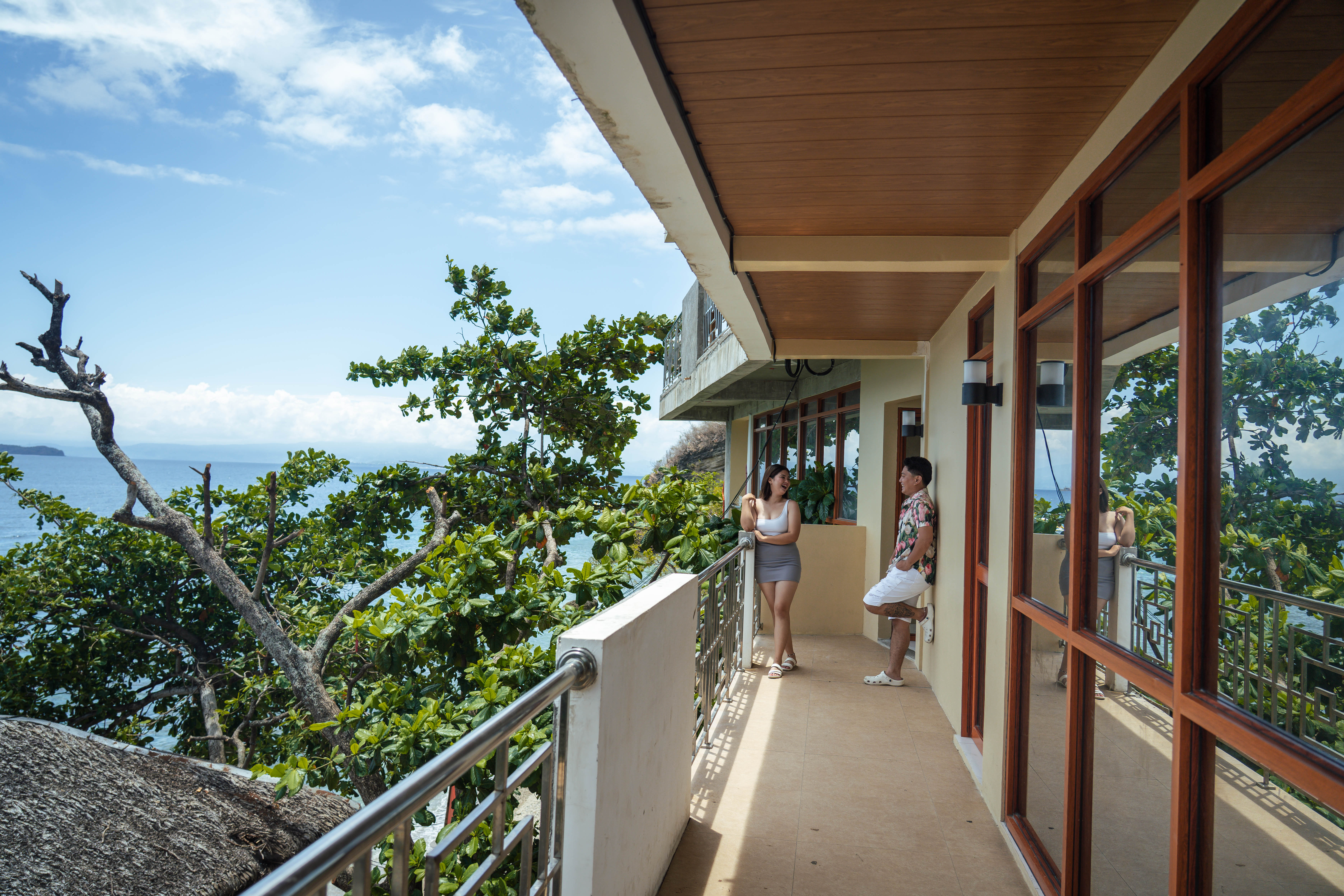 Guests on the ocean-view balcony overlooking the sea at Brizamar Beach Resort Batangas City